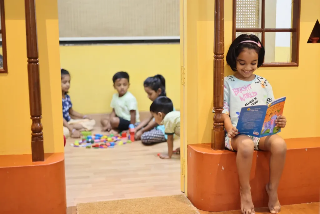 Children reading picture books in a cosy reading corner at Williez Preschool