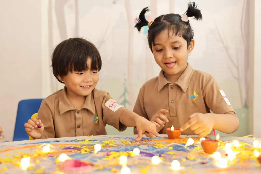 Two children working on a craft activity together at Williez Preschool, India