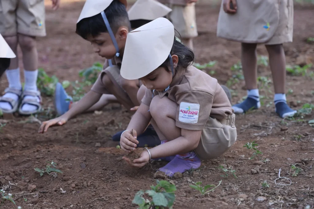 Children digging in the soil during a farm activity at Williez Preschool, India
