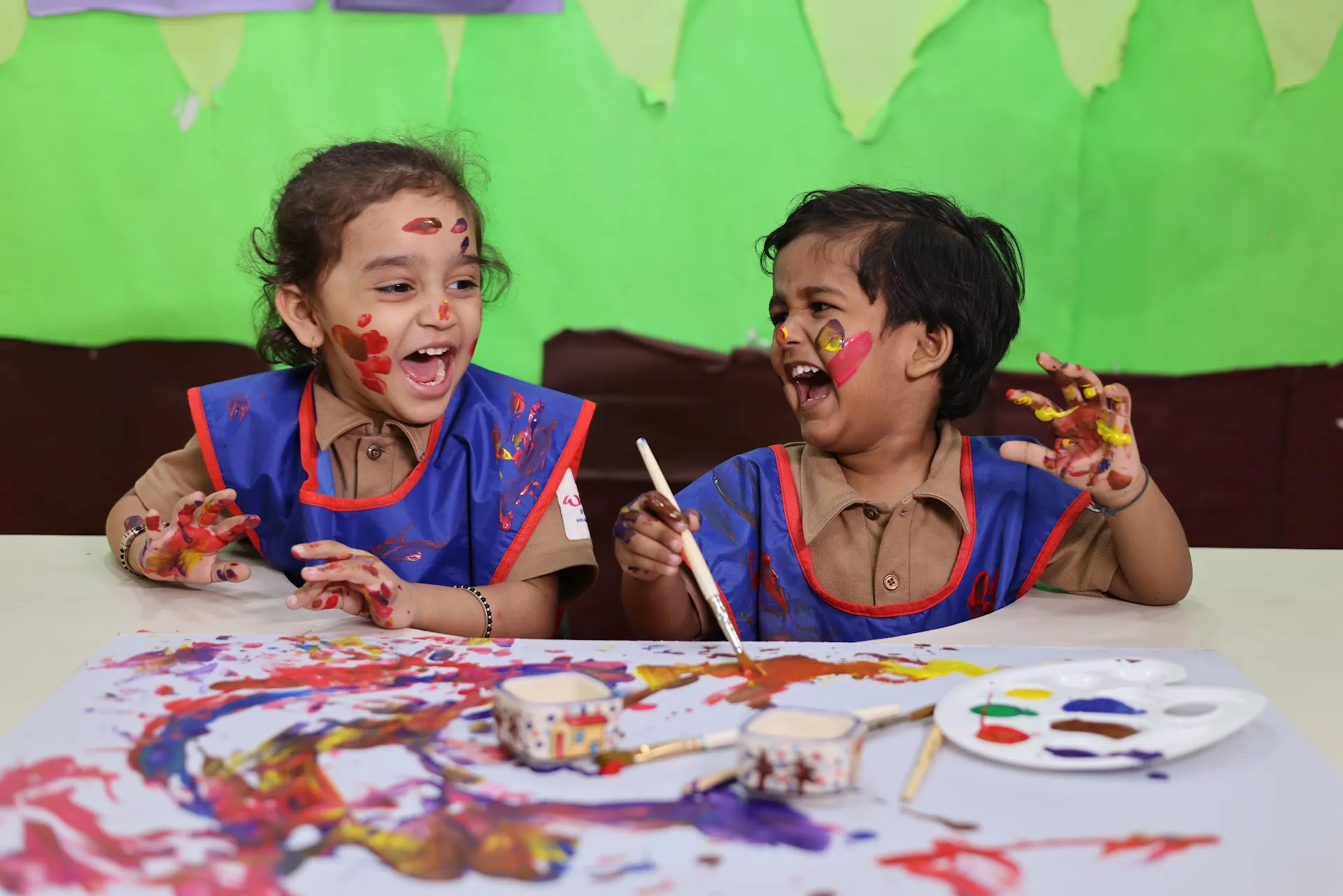 Children having fun with messy painting at Williez Preschool, India
