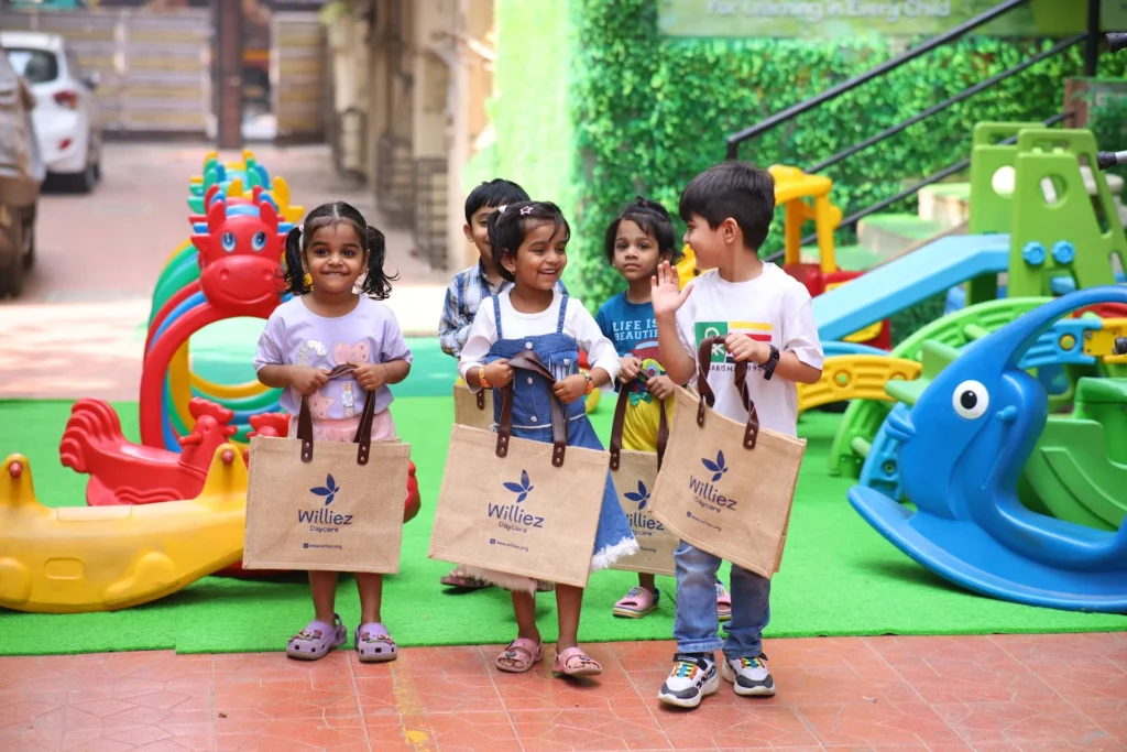 Happy preschoolers celebrating together in the outdoor play area at Williez Preschool, India