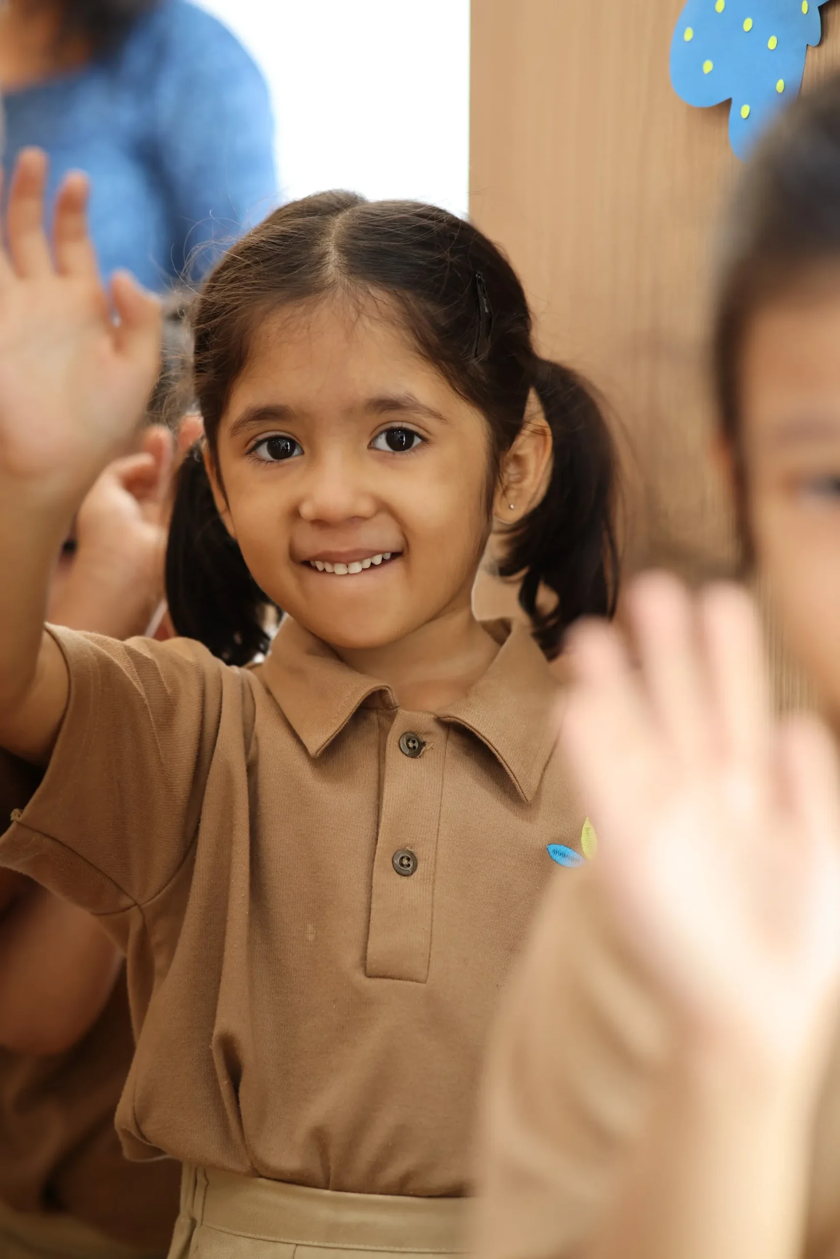 Happy preschool girl smiling in class at Williez Preschool, India