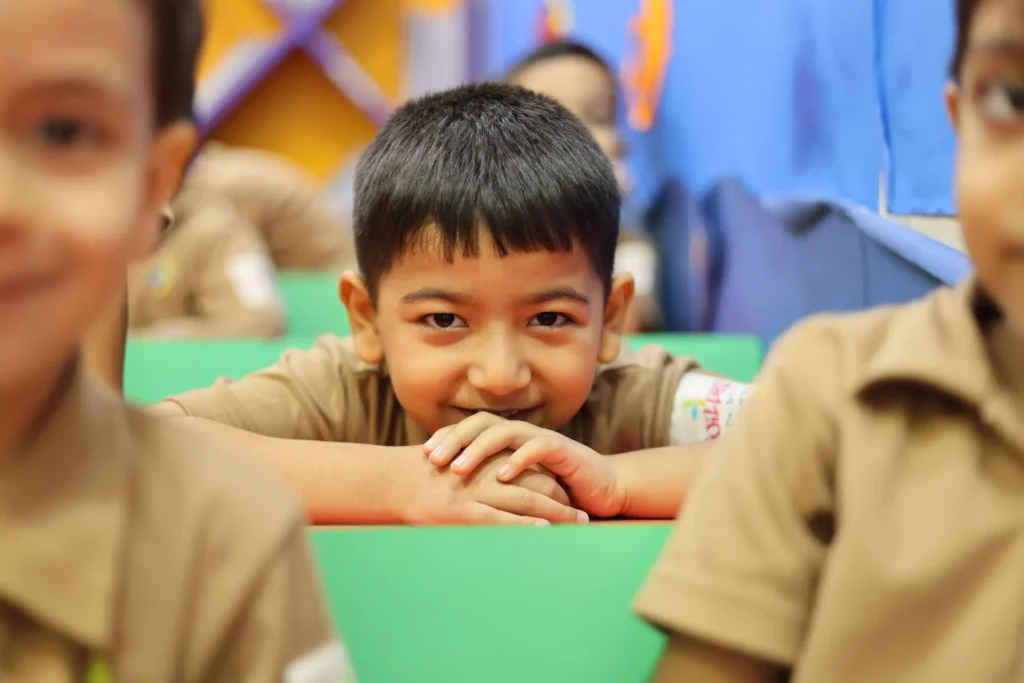 Smiling boy enjoying time in the classroom at Williez Preschool, India